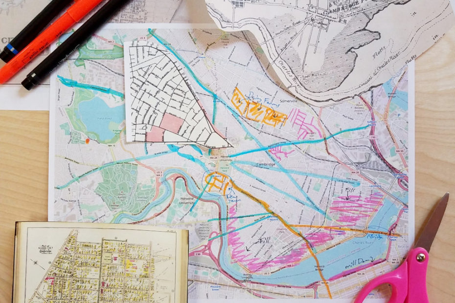 Map of Cambridge, MA that is marked up with pen and highlighter to show earlier uses, with cut out pieces of historic maps, some pens and a pair of pink handled scissors.